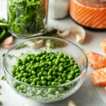 Fresh ingredients for a healthy fish food recipe, including shrimp, spinach, peas, and seaweed, being prepared in a light and vibrant kitchen setting.